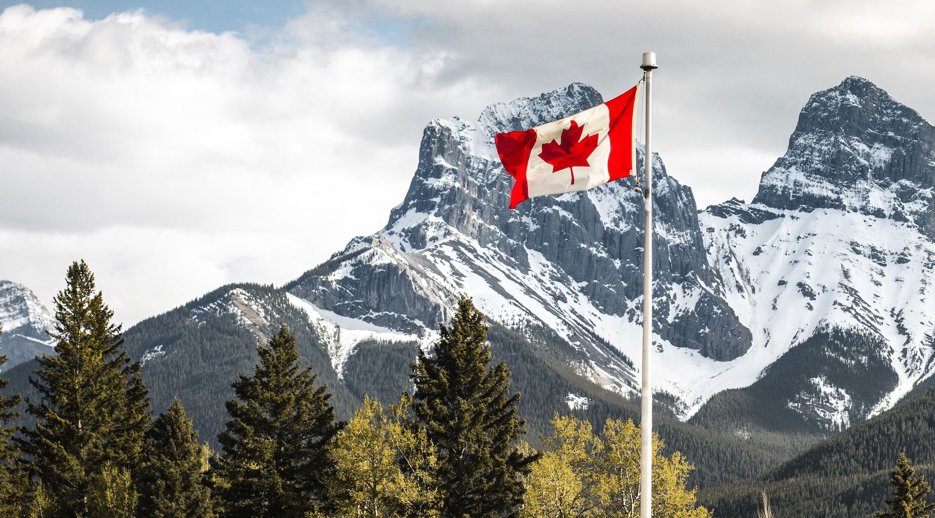 Canada flag against mountain backdrop